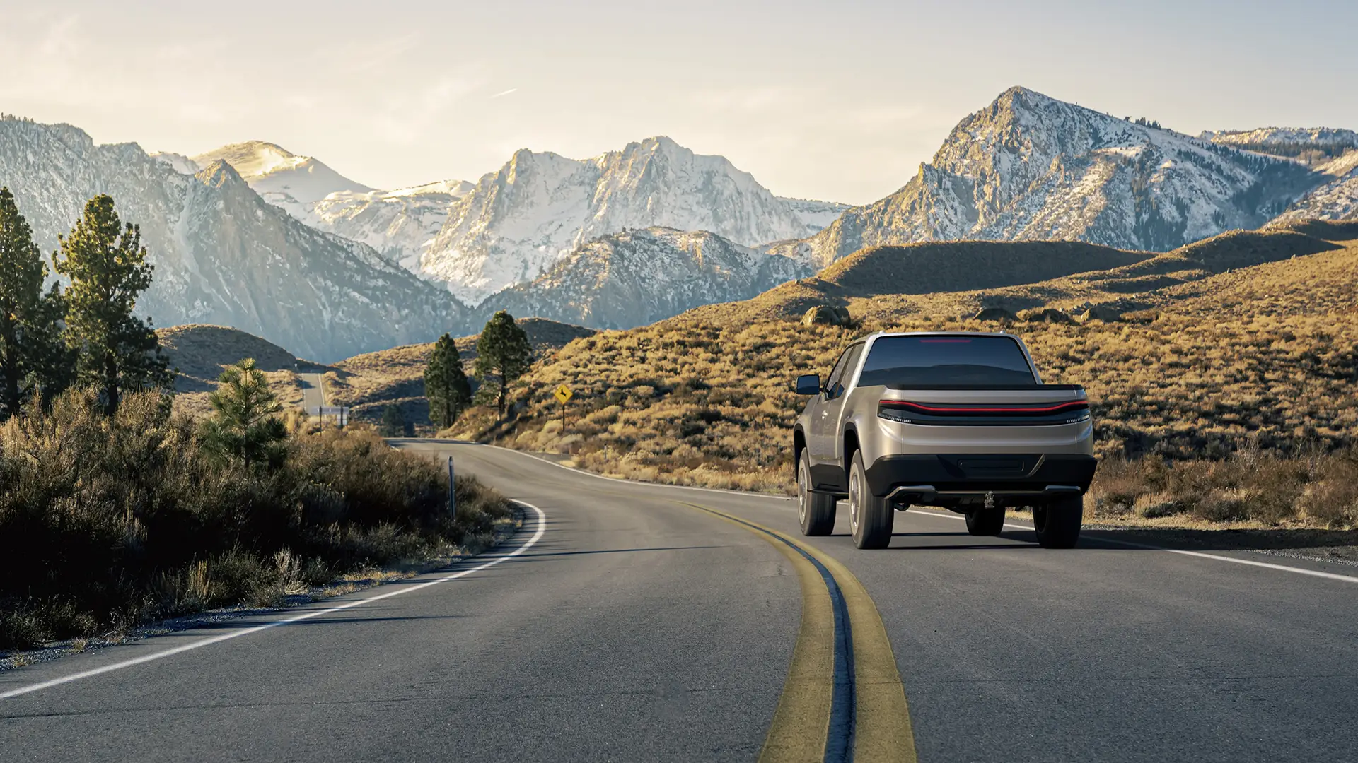 A pickup truck driving through a paved street in the desert.