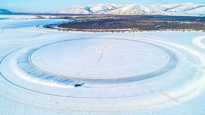 Top view of ice and snow circle on lake